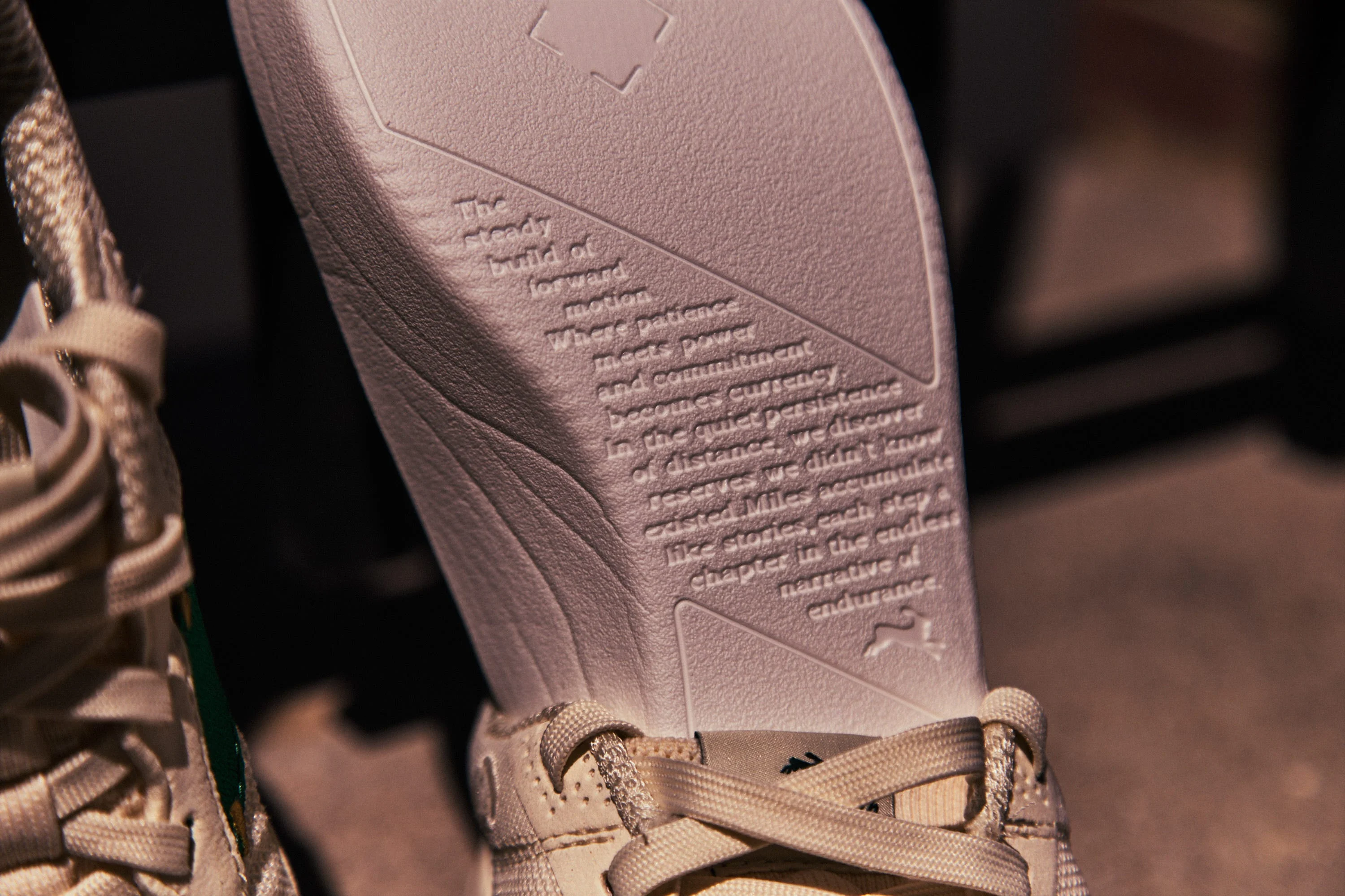 Shoe insole with motivational text about endurance and persistence.
