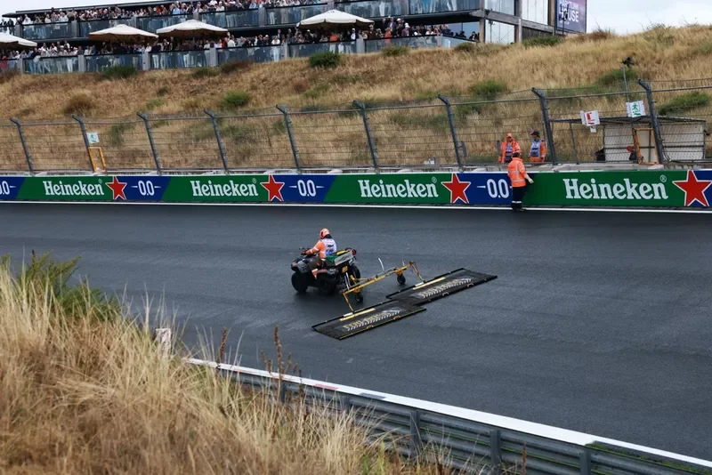 Marshals work on the track surface