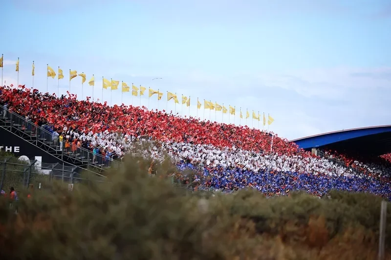 Fans form the Dutch flag colours