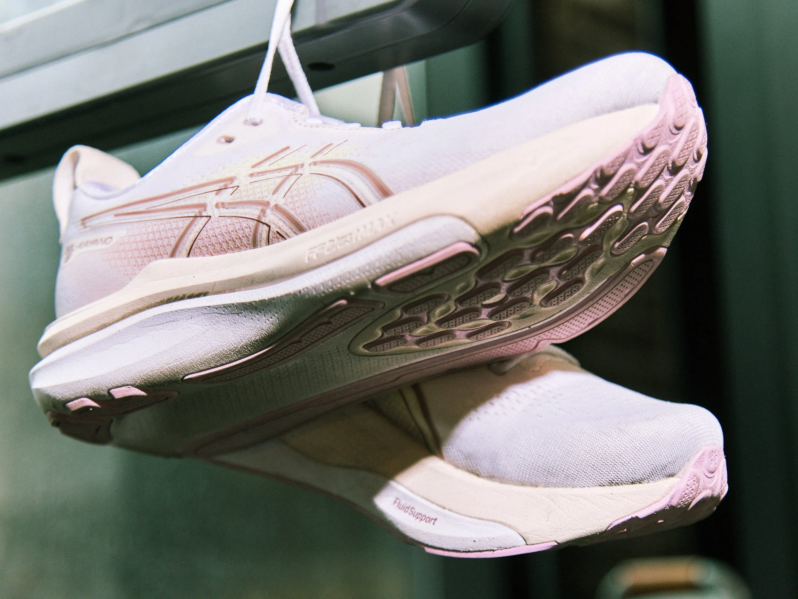 Asics Gel Kayano 33 shoes hanging from a display with focus on the sole and upper design. Asics Gel Kayano 33 shoes hanging from a display with focus on the sole and upper design.