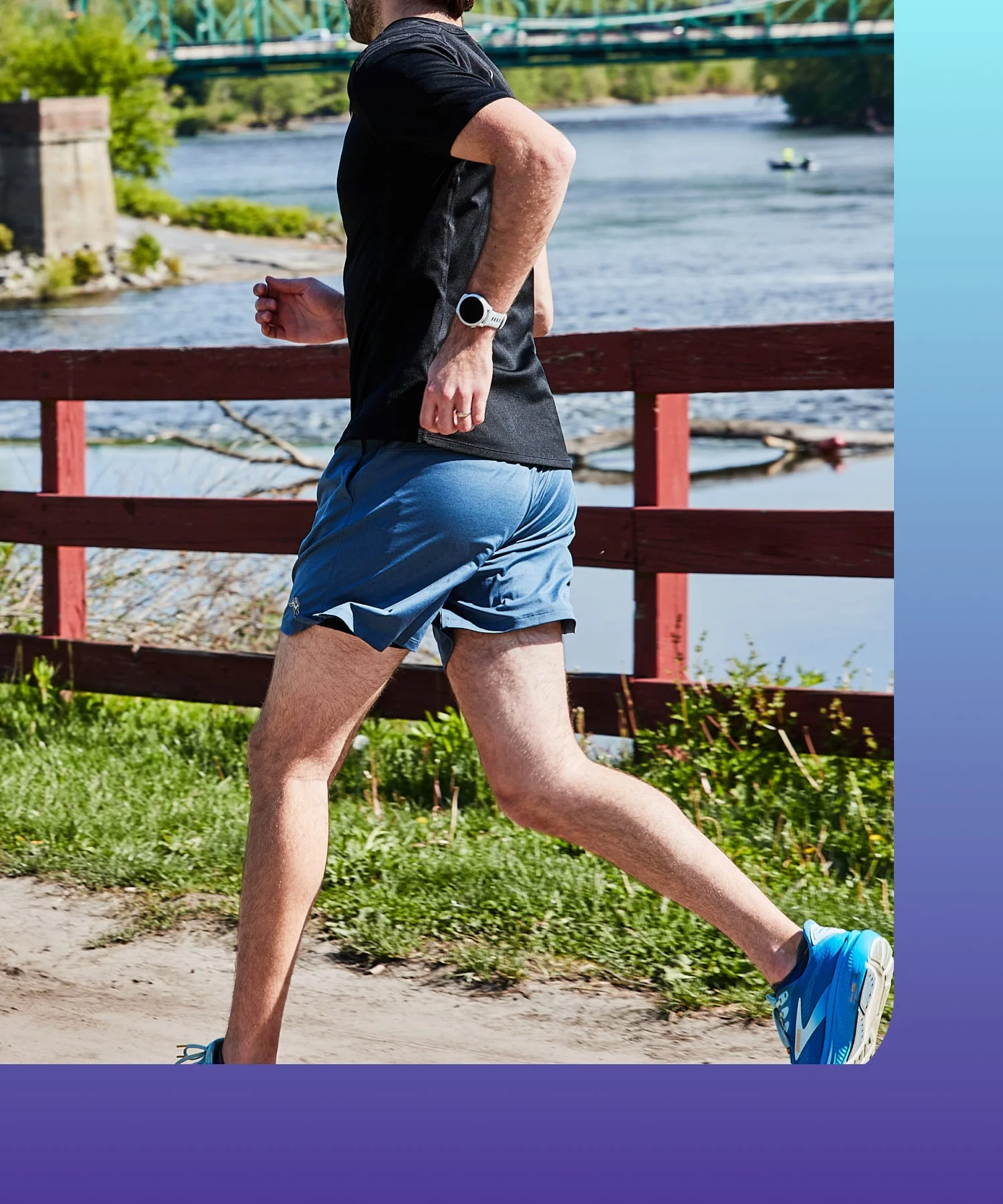 Person jogging along a riverbank.
