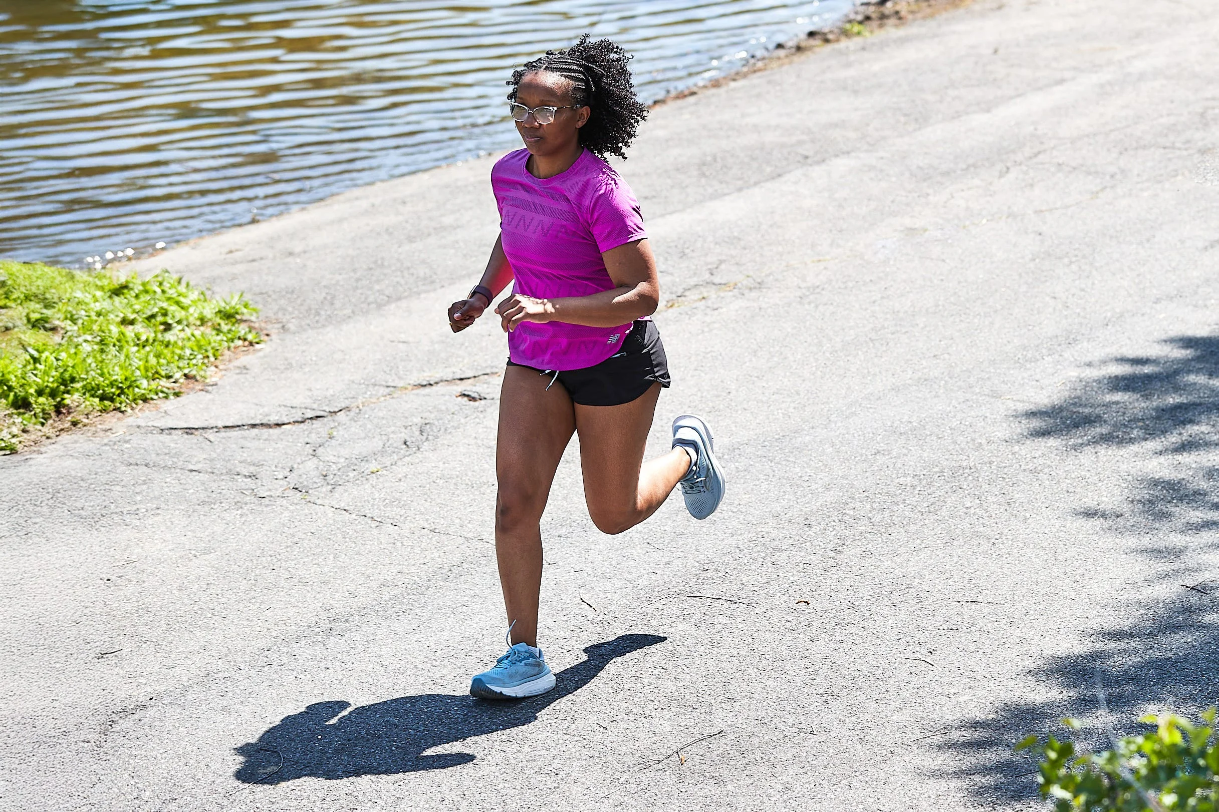 runner on asphalt path next to water