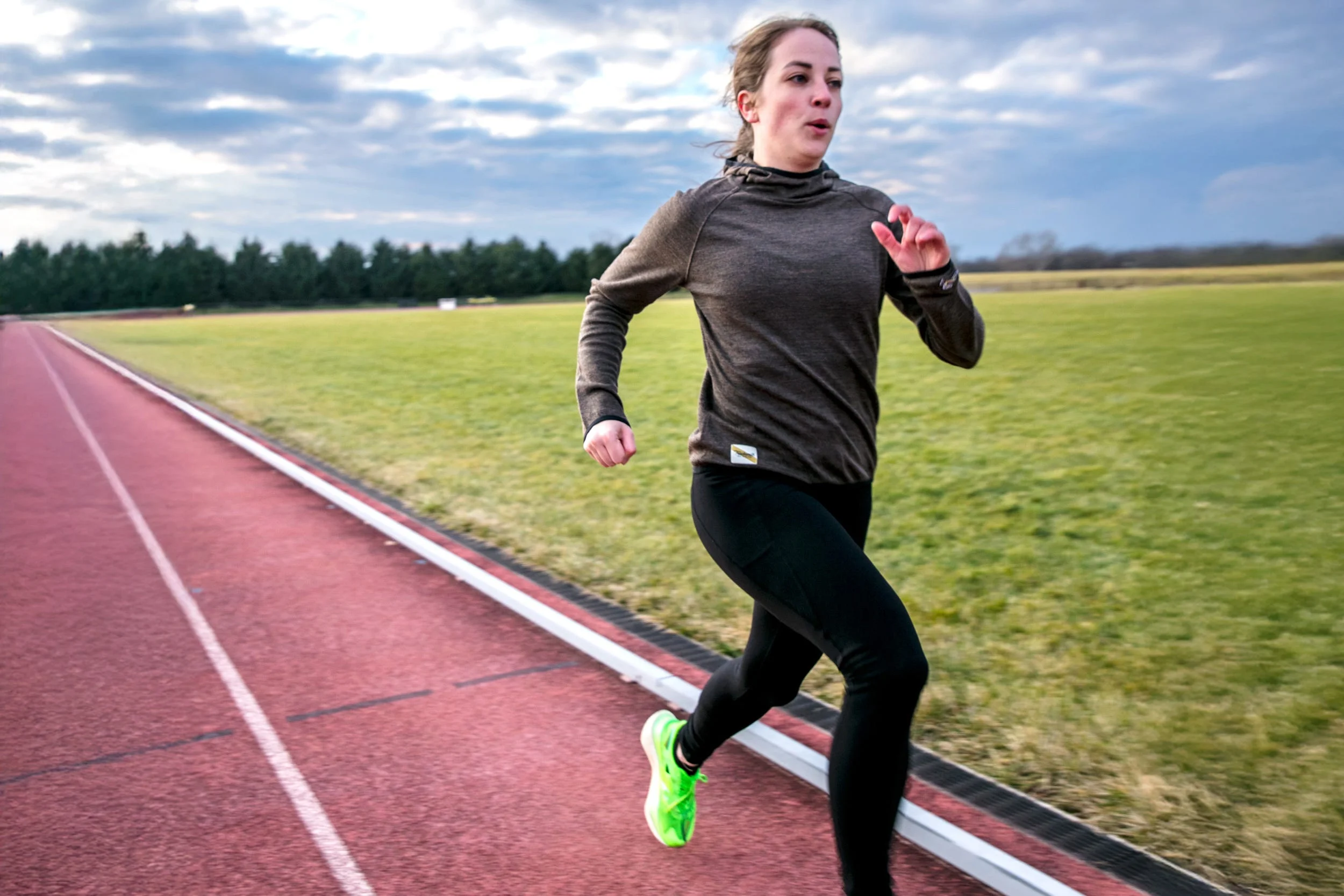 runner taking strides on track