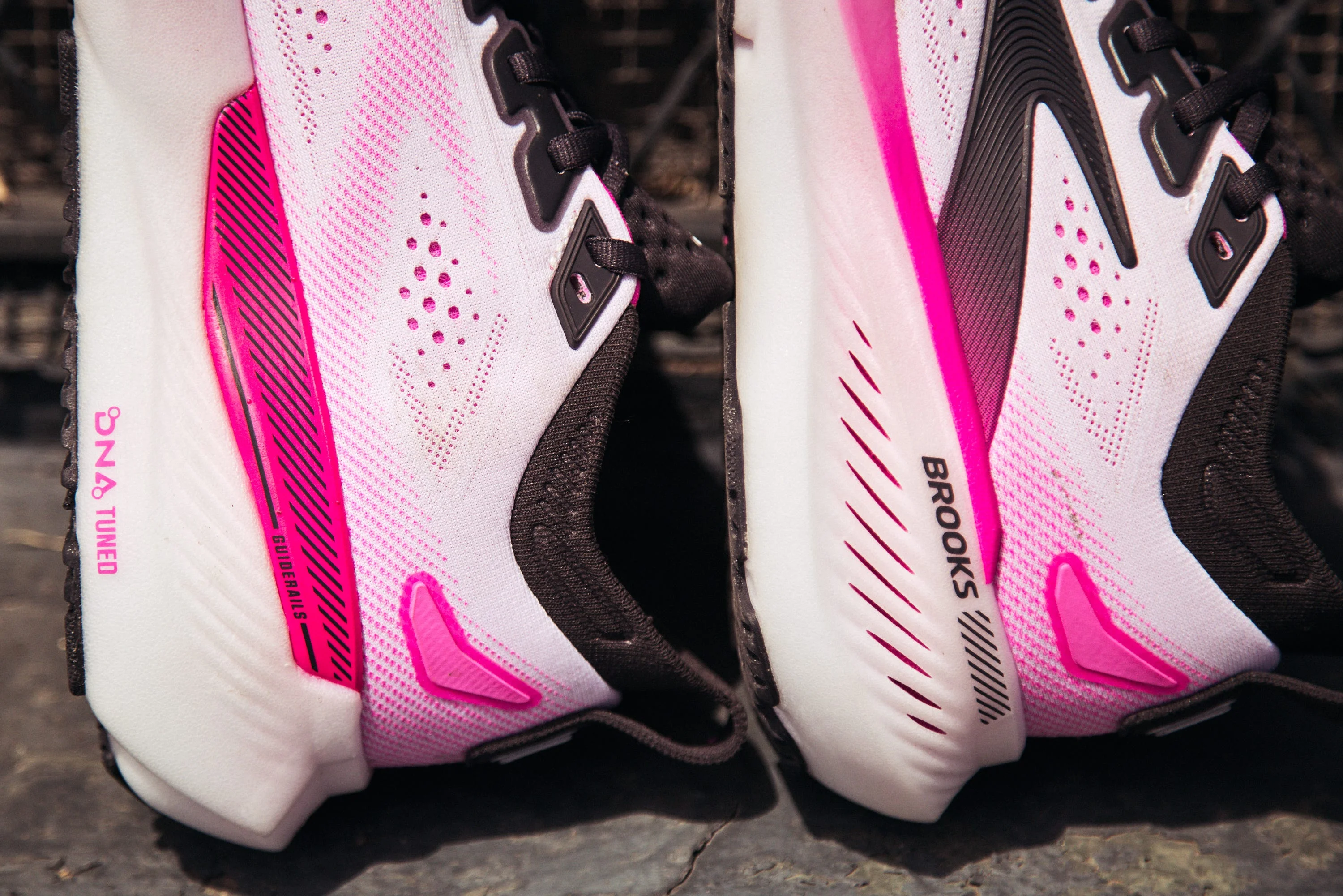Close-up of black and white running shoes with pink accents. Close-up of black and white running shoes with pink accents.