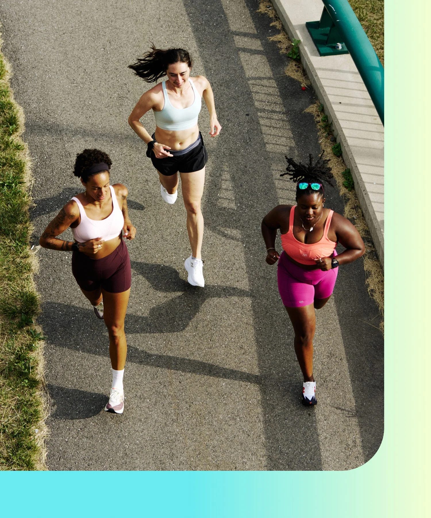 three runners in sports bras on paved path three runners in sports bras on paved path