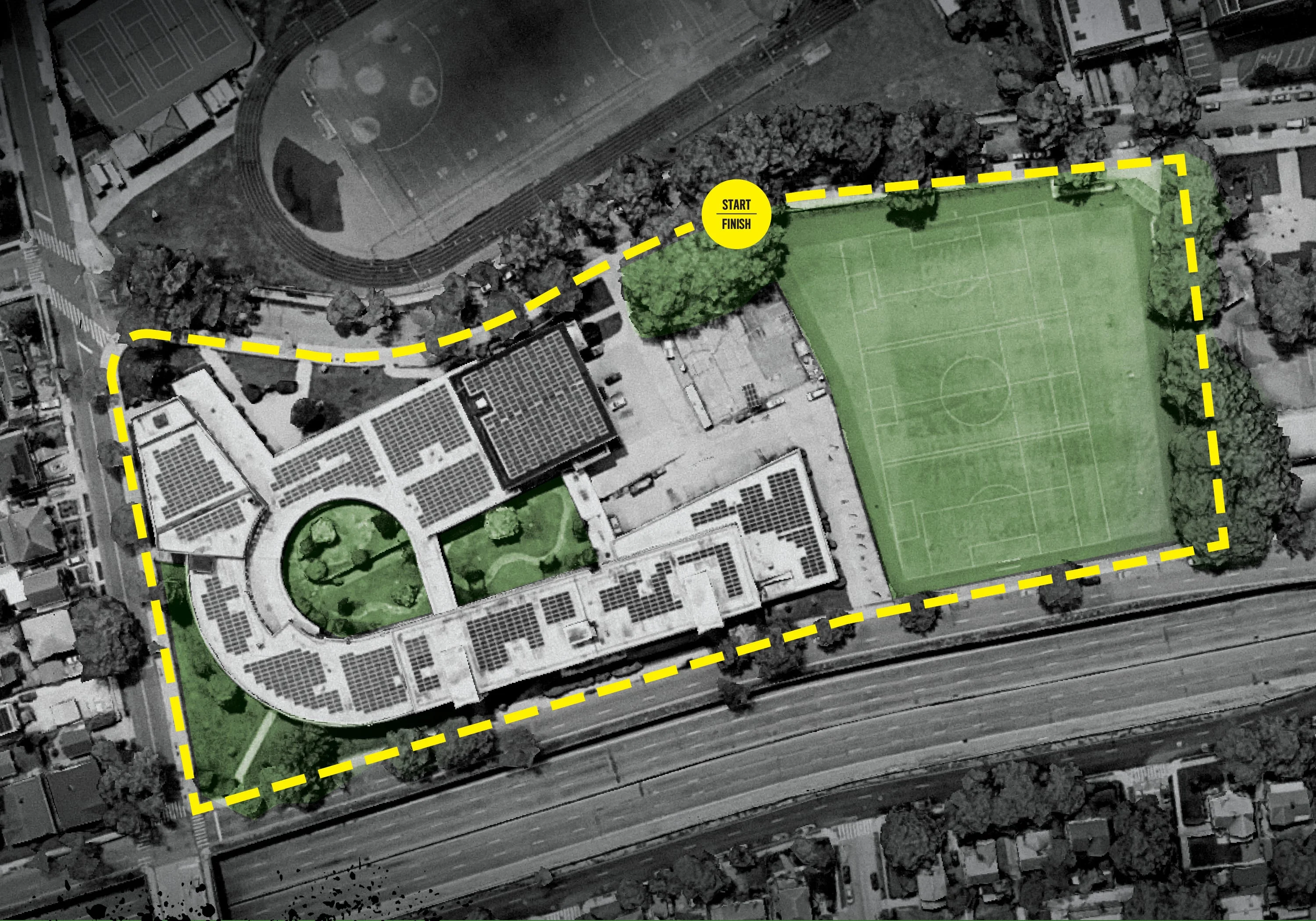 Aerial view of a building and sports field bordered by a yellow dashed line. Aerial view of a building and sports field bordered by a yellow dashed line.